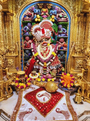 Close-up of a beautifully decorated Hanuman idol in a temple setting.