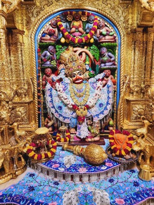Ornate golden idol of Hanuman Ji in a temple