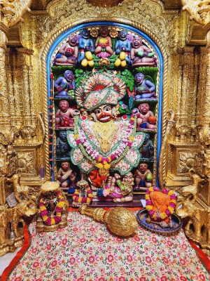 Close-up of a beautifully decorated Hanuman idol within a temple archway.