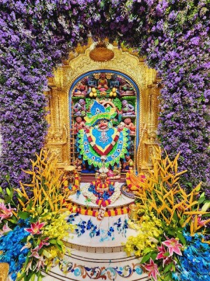 A beautifully decorated Hanuman temple covered in vibrant flowers.