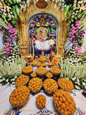Decorated shrine of Hanuman Ji with offerings of sweets