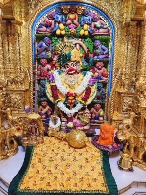 Close-up of a beautifully decorated Hanuman idol in a temple setting.