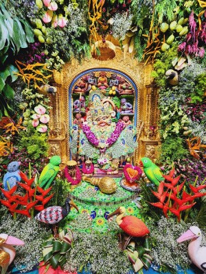 A beautifully decorated shrine of Lord Hanuman adorned with flowers and fruits.