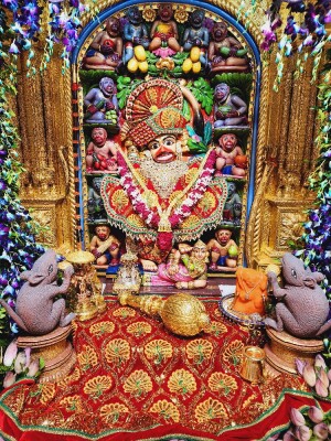 Close-up of a beautifully decorated Hanuman idol in a temple setting.