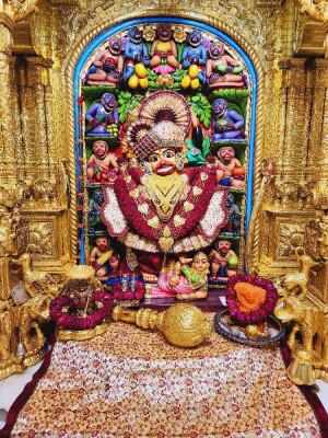 Close-up of a beautifully decorated Hanuman idol in a temple setting.