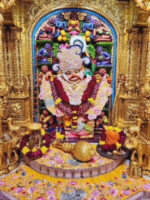 Close-up of a beautifully decorated Hanuman idol within a temple archway.