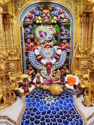 Close-up of a beautifully decorated Hanuman idol in a temple setting.
