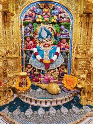 Close-up of a beautifully decorated Hanuman idol in a temple setting.
