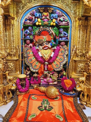 Close-up of a beautifully decorated Hanuman idol in a temple setting.