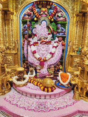 Close-up of a beautifully decorated Hanuman idol in a temple setting.