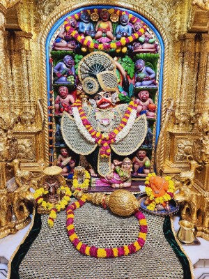 Close-up of a beautifully decorated Hanuman idol in a temple setting.