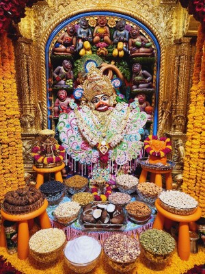 Close-up of Hanuman idol adorned with flowers and offerings
