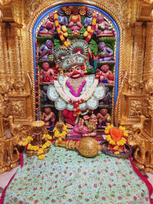 Close-up of a beautifully decorated Hanuman idol in a temple setting.