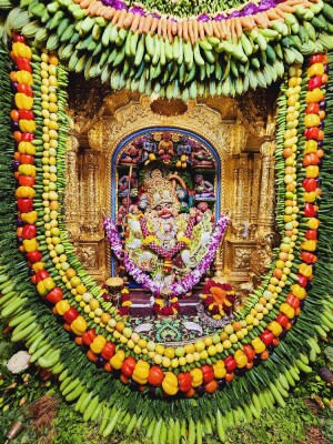 A beautifully decorated idol of Hanuman Ji with fruits and flowers