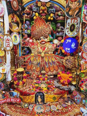 Close-up of a vibrant Hanuman deity statue in a richly decorated temple