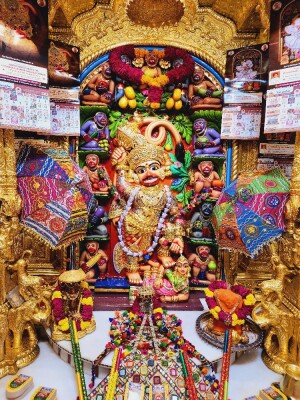 Intricate depiction of Hanuman Ji in a richly decorated temple setting.