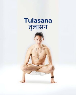 Man performing Tulasana yoga pose