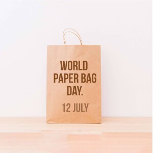 A brown paper bag with the text 'World Paper Bag Day. 12 July' printed on it.