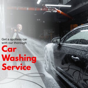 Woman washing a black car with a high-pressure hose in a car wash bay.