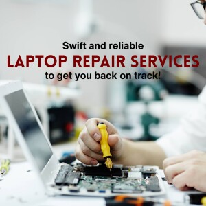 A technician repairing a laptop motherboard with a screwdriver.