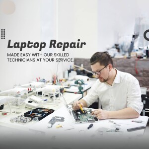 Technician repairing a laptop with tools and disassembled parts on a workbench.