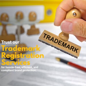 Hand stamping the word 'TRADEMARK' onto documents representing trademark registration services.