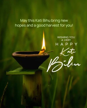 A lit diya lamp with Kati Bihu wishes