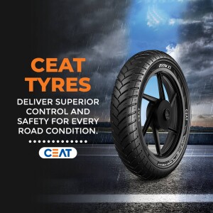 CEAT Tyre advertisement showcasing a motorcycle tyre with a city skyline background.
