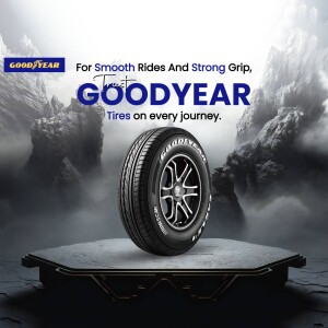 Goodyear tire on a pedestal with a mountain backdrop