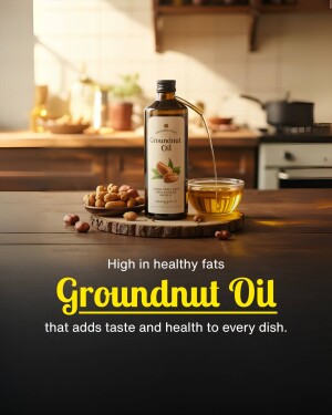 Bottle of groundnut oil with peanuts and a glass of oil being poured
