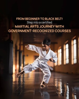 Young boy in a white karate gi practicing a martial arts move in a dojo.