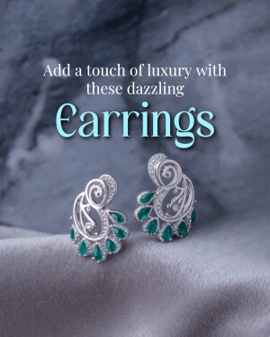 Close-up of elegant silver earrings with emerald gemstones