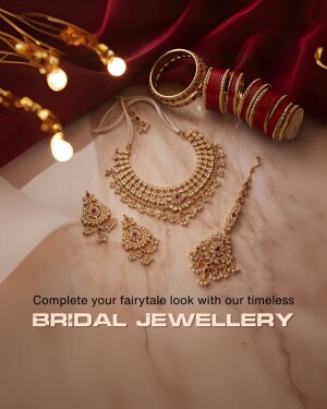 Close-up of gold and red bridal jewellery set on a marble surface