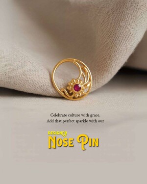 Close-up of a gold nose pin with a red ruby gemstone