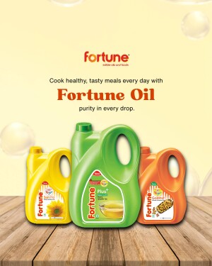 Fortune edible oils in yellow, green, and orange bottles on a wooden surface.