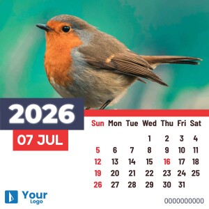 Close-up of a robin perched on a branch with a 2025 calendar in the foreground