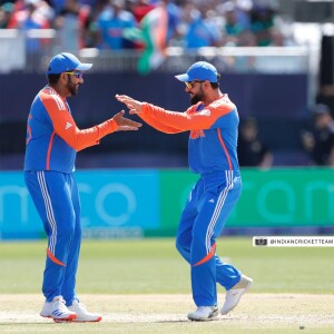 Two Indian cricketers celebrating a wicket during a match