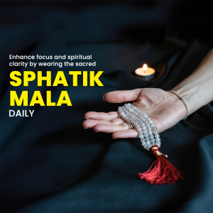 Hand holding a Spatik Mala with a candle in the background