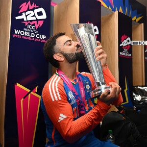 Virat Kohli kissing the ICC Men's T20 World Cup trophy
