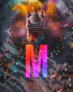 Aerial view of a temple surrounded by people celebrating Holi with vibrant colors.