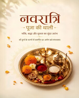 A traditional brass Navratri puja thali with marigold flowers, vermilion, rice, and a lit diya lamp on a light cream background.