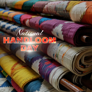 A stack of colorful handloom fabrics with 'National Handloom Day' text overlay