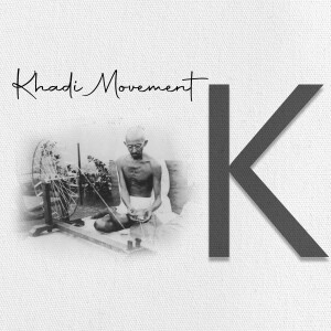 Black and white image of Mahatma Gandhi spinning khadi with a large letter 'K' beside him.