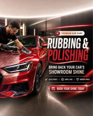 A technician using a buffer to polish a shiny red luxury car in a modern detailing workshop.
