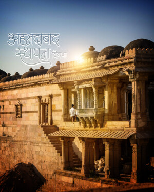 Historical architecture in Ahmedabad, India with a person standing on a balcony.