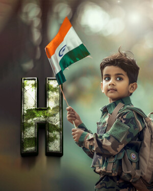 A young boy in army attire holding the Indian flag.
