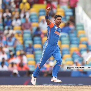 Indian cricketer in blue jersey celebrating with a raised fist during a match