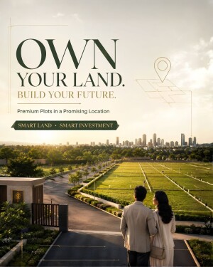 A couple standing in front of a landscaped land plot development with a city skyline in the background