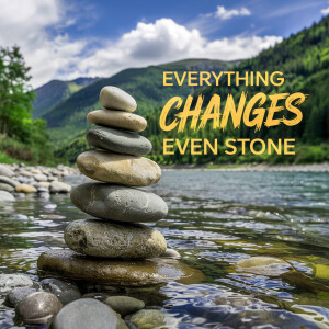 Stacked stones with a mountain and river background