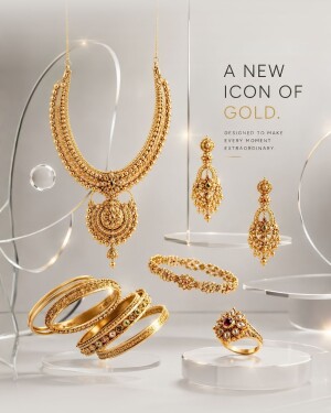 Luxury gold necklace, earrings, bangles, and ring displayed on glass stands